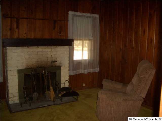 174 Pinehurst Road Brick, NJ 08723 - Photo 3 of 3 a living room with furniture and a fireplace