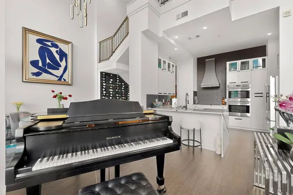 a kitchen with a stove a cabinets and a dining table with wooden floor