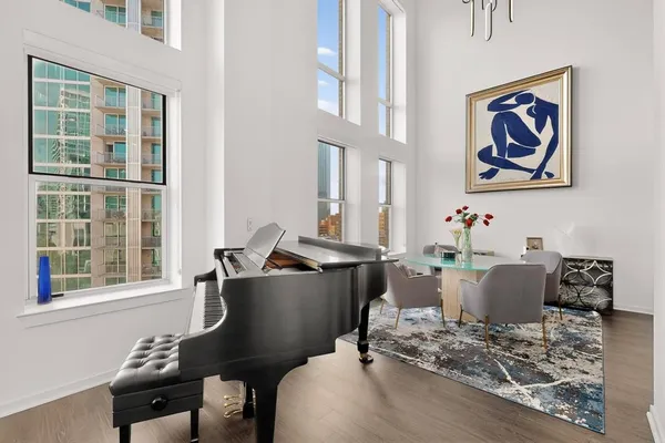 a living room with furniture and wall paintings