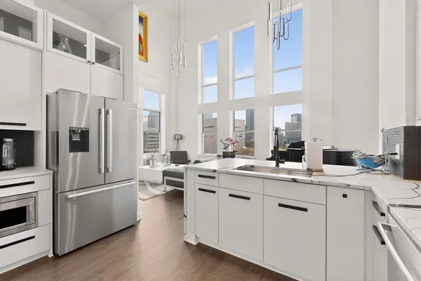 a kitchen with a sink a refrigerator a stove and cabinets