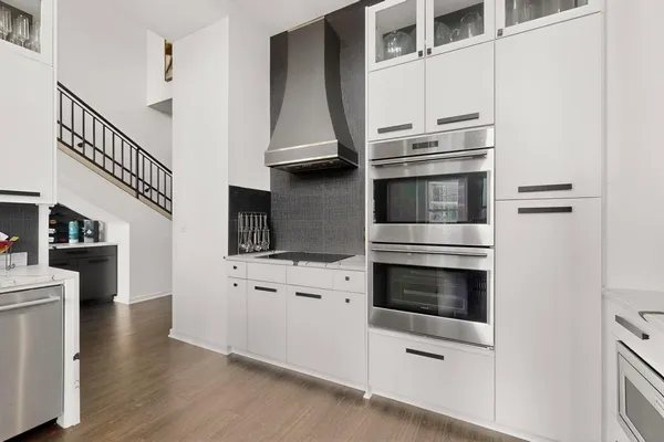a kitchen with stainless steel appliances and white cabinets