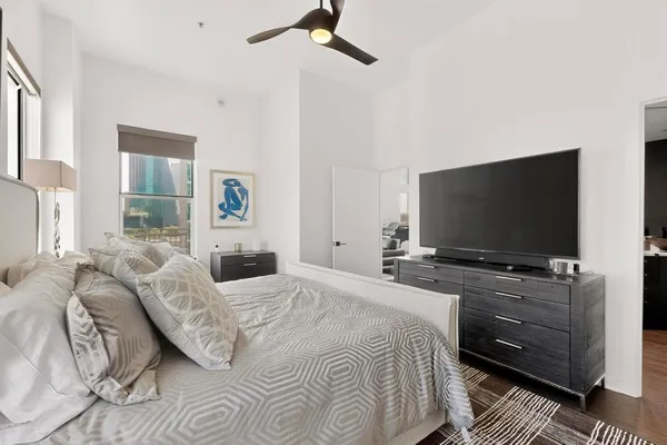 a bedroom with a bed and a flat screen tv
