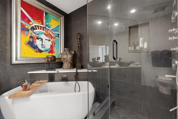 a bathroom with a sink and mirror with toilet