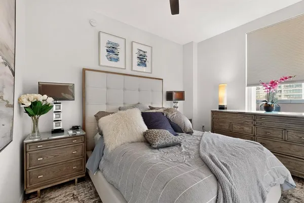 a bedroom with a bed and a potted plant
