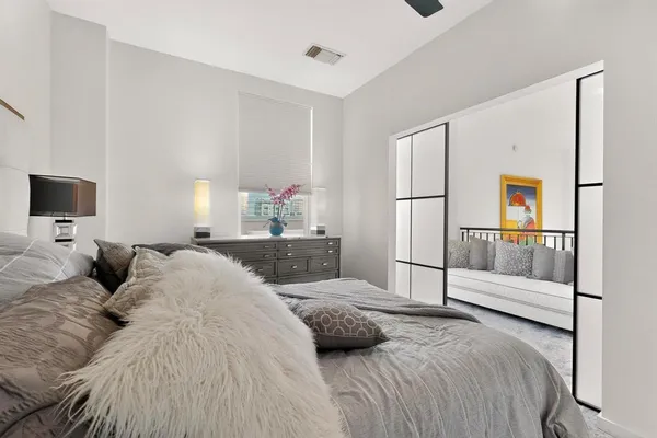 a bedroom with a bed and a flat screen tv