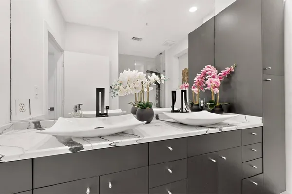 a bathroom with a sink vanity and a mirror