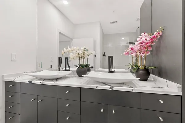 a bathroom with a granite countertop sink a mirror and a sink