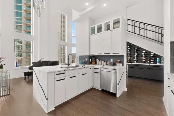 a white kitchen with sink and cabinets