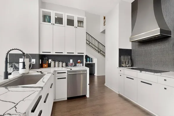 a kitchen with stainless steel appliances granite countertop a sink and a stove