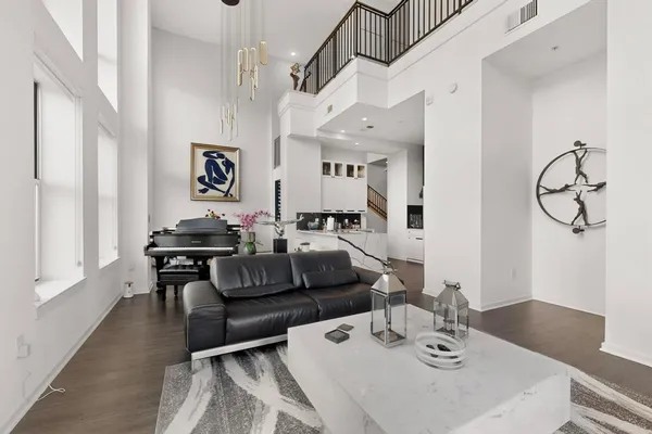 a living room with furniture and wooden floor