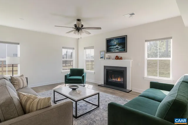 a kitchen with stainless steel appliances granite countertop a sink a stove a refrigerator cabinets and chairs