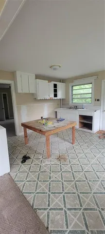 a kitchen with granite countertop a rug stove and cabinets