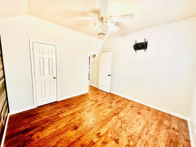 a view of room with window and wooden floor