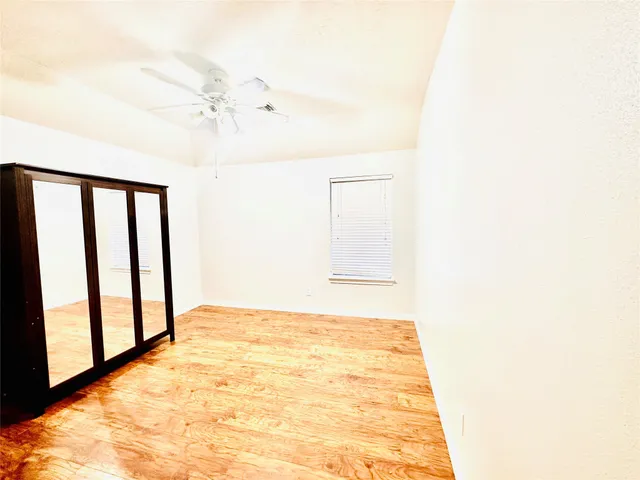 a view of a room with a ceiling fan