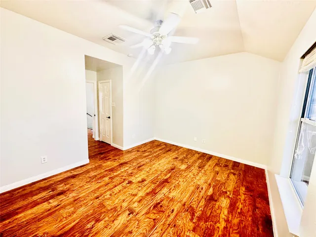 a bedroom with a bed and a mirror