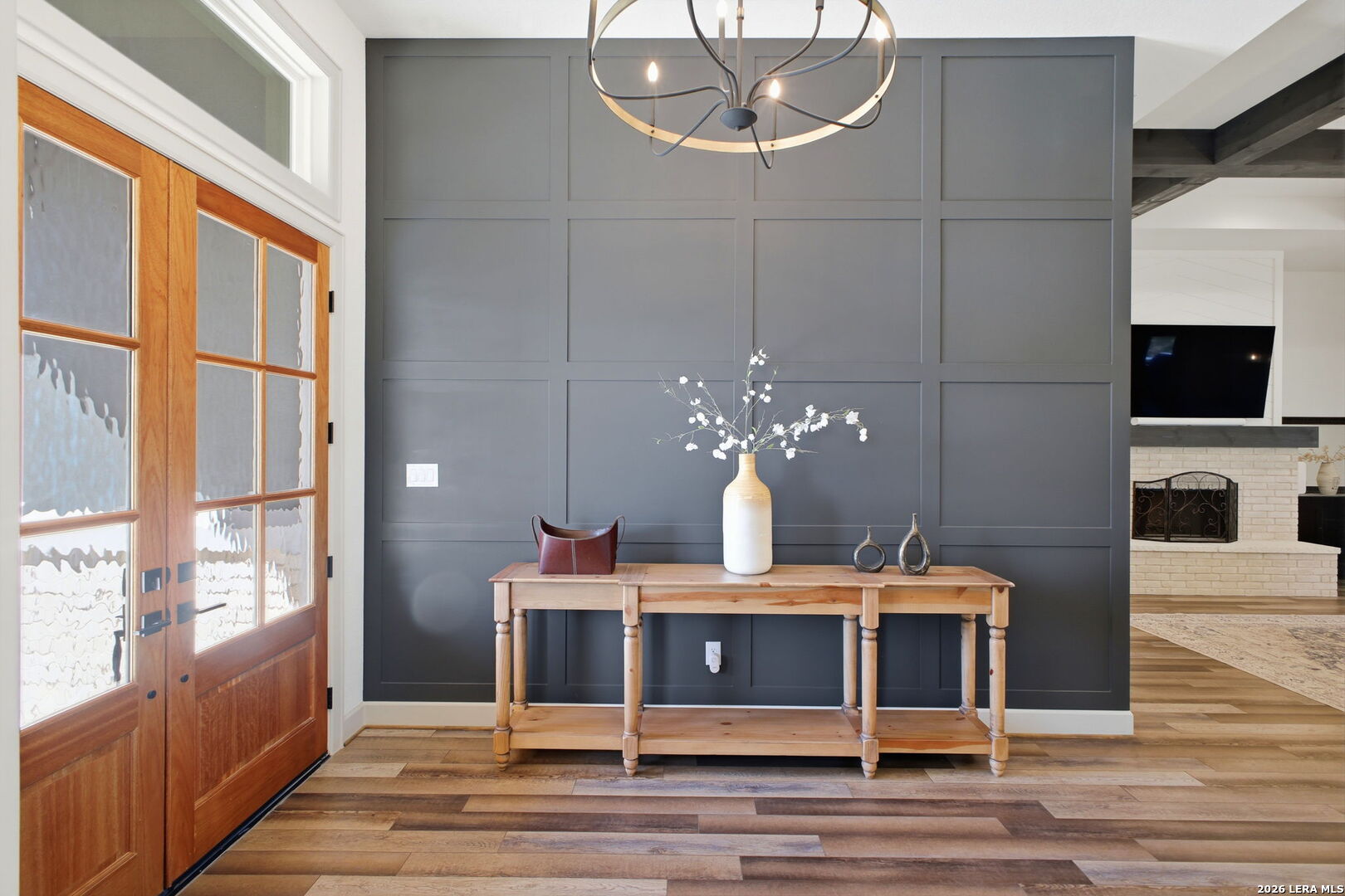 321 Vista View Place Spring Branch, TX 78070 - Photo 15 of 50 a room with a chandelier and wooden floor