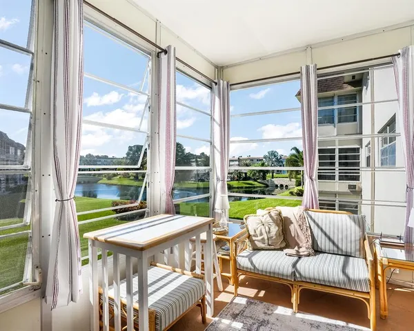 a balcony with furniture and a large window