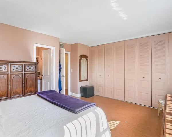 a bedroom with a bed and a closet