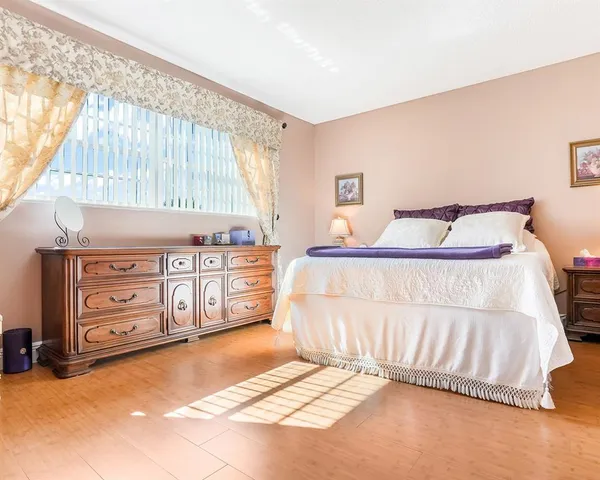 a bedroom with a bed and a tv