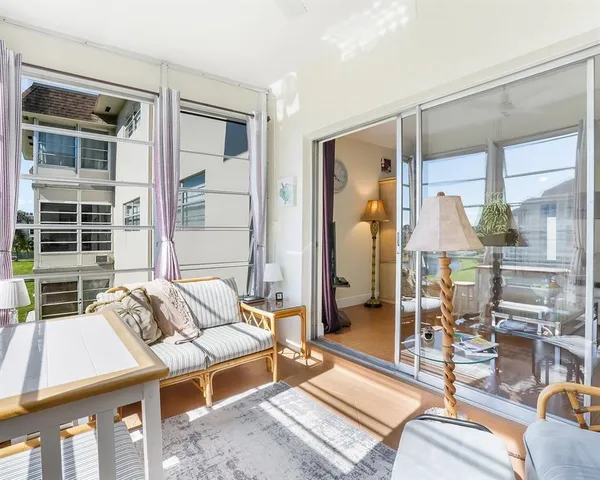 a bedroom with a bed and glass windows