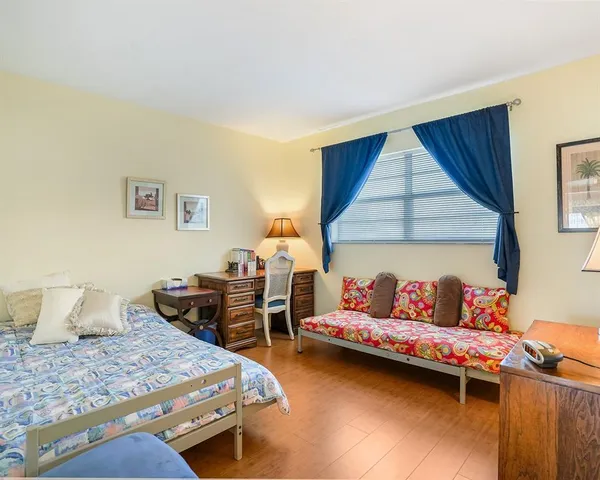 a bedroom with bed and window