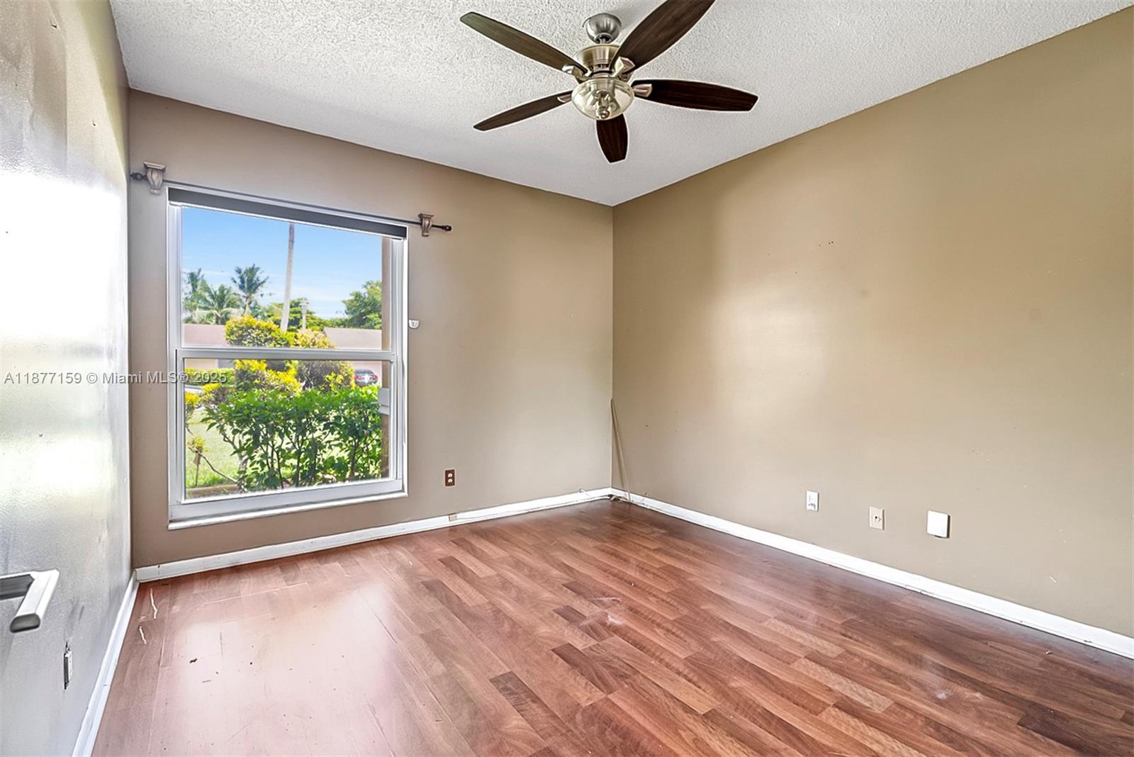 3568 Southwest 69th Way Miramar, FL 33023 - Photo 19 of 32 wooden floor in an empty room with a window