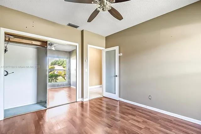 a view of empty room with wooden floor