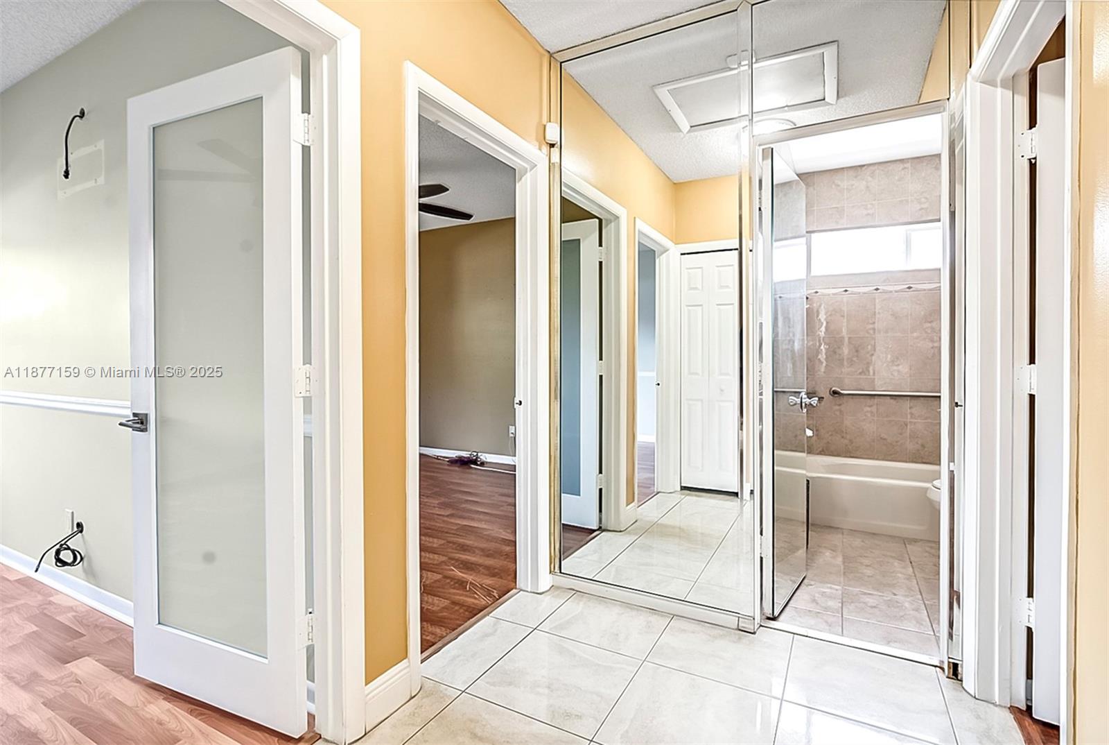 3568 Southwest 69th Way Miramar, FL 33023 - Photo 22 of 32 a bathroom with a glass shower door and a glass door