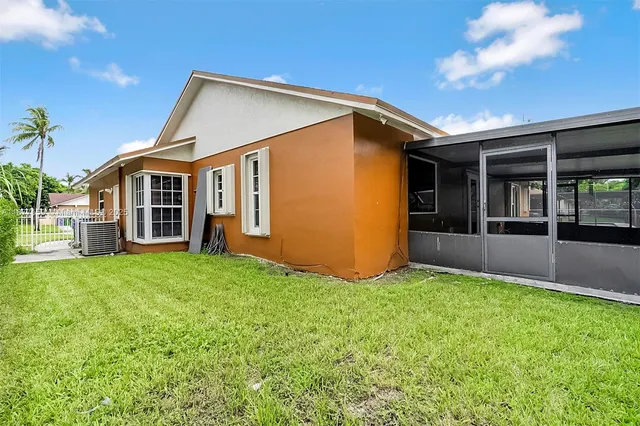 a view of house with backyard