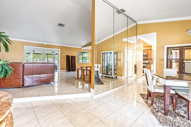 a view of a dining room with furniture wooden floor and a chandelier