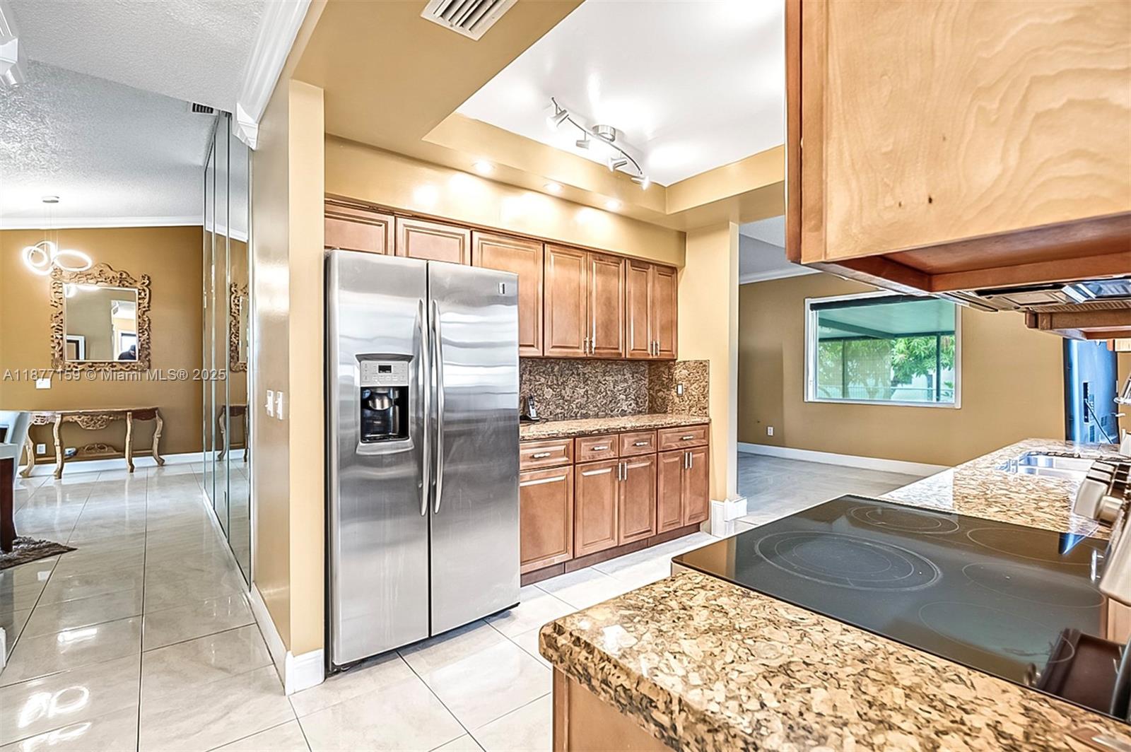 3568 Southwest 69th Way Miramar, FL 33023 - Photo 10 of 32 a kitchen with stainless steel appliances granite countertop a refrigerator and a sink