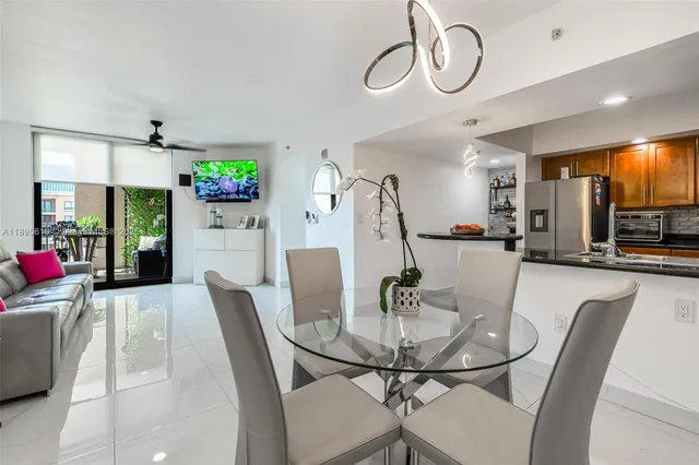 a view of a dining room with furniture and a chandelier