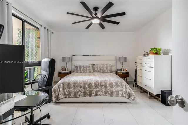 a bedroom with a bed and a computer on a desk