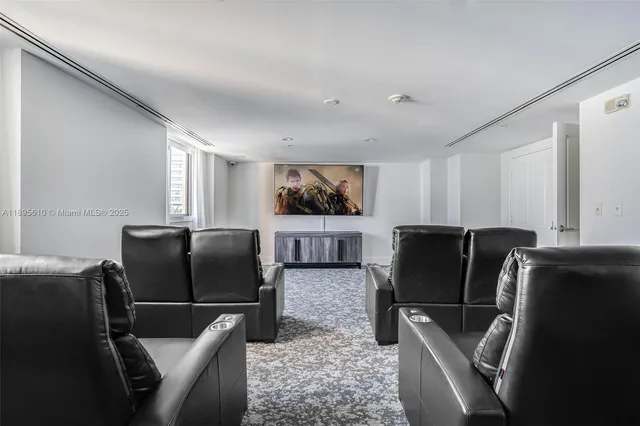 a living room with furniture and large windows