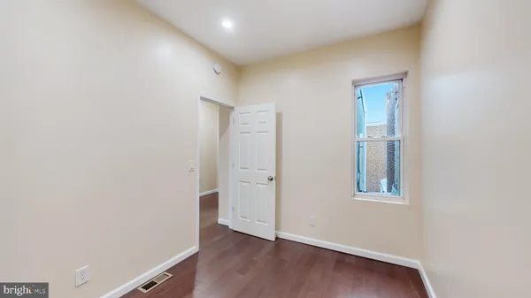 an empty room with wooden floor