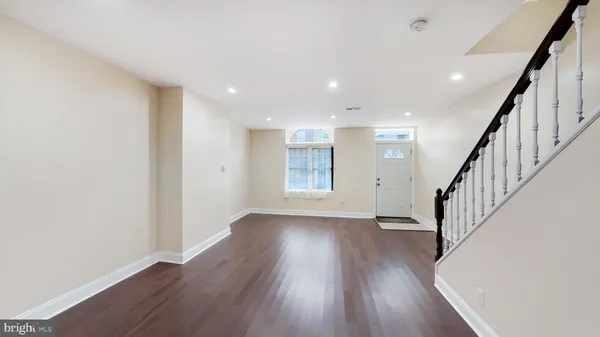 a view of entryway and hall with wooden floor