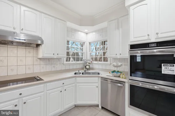 a kitchen with a sink appliances and cabinets