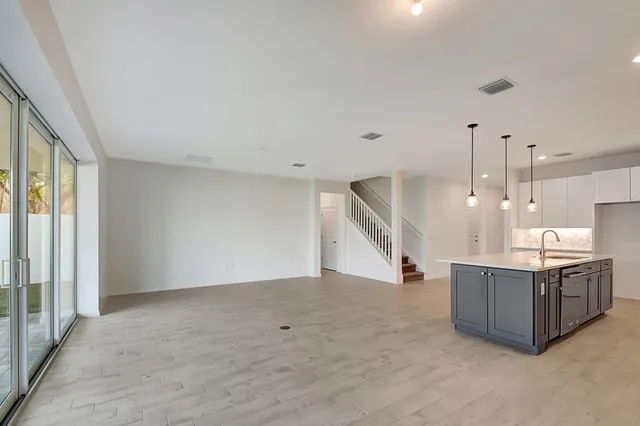 a view of a kitchen with a sink and a window