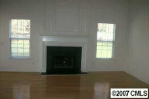 7016 Reedy Creek Road Charlotte, NC 28215 - Photo 3 of 6 a living room with a fireplace