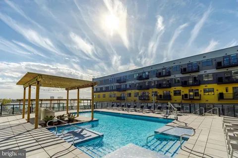 a view of a swimming pool with furniture