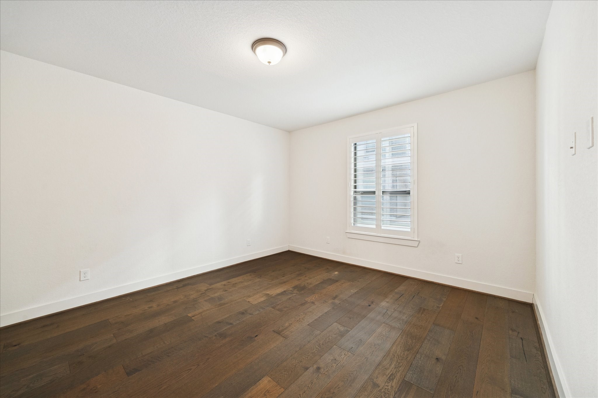 1122 Thompson Street Houston, TX 77007 - Photo 25 of 25 an empty room with wooden floor and windows