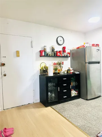 a kitchen with refrigerator and window