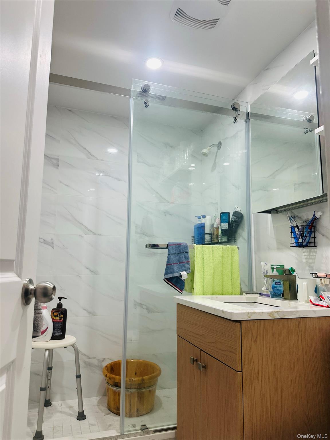 42-55 Colden Street, Unit 8N Queens, NY 11355 - Photo 7 of 7 a bathroom with a granite countertop sink mirror and shower