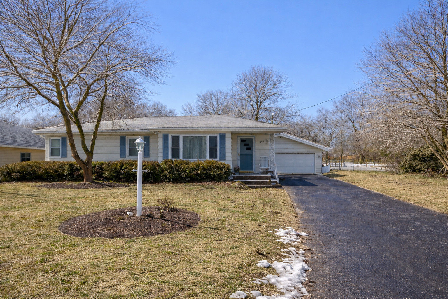 a front view of a house with a yard and trees