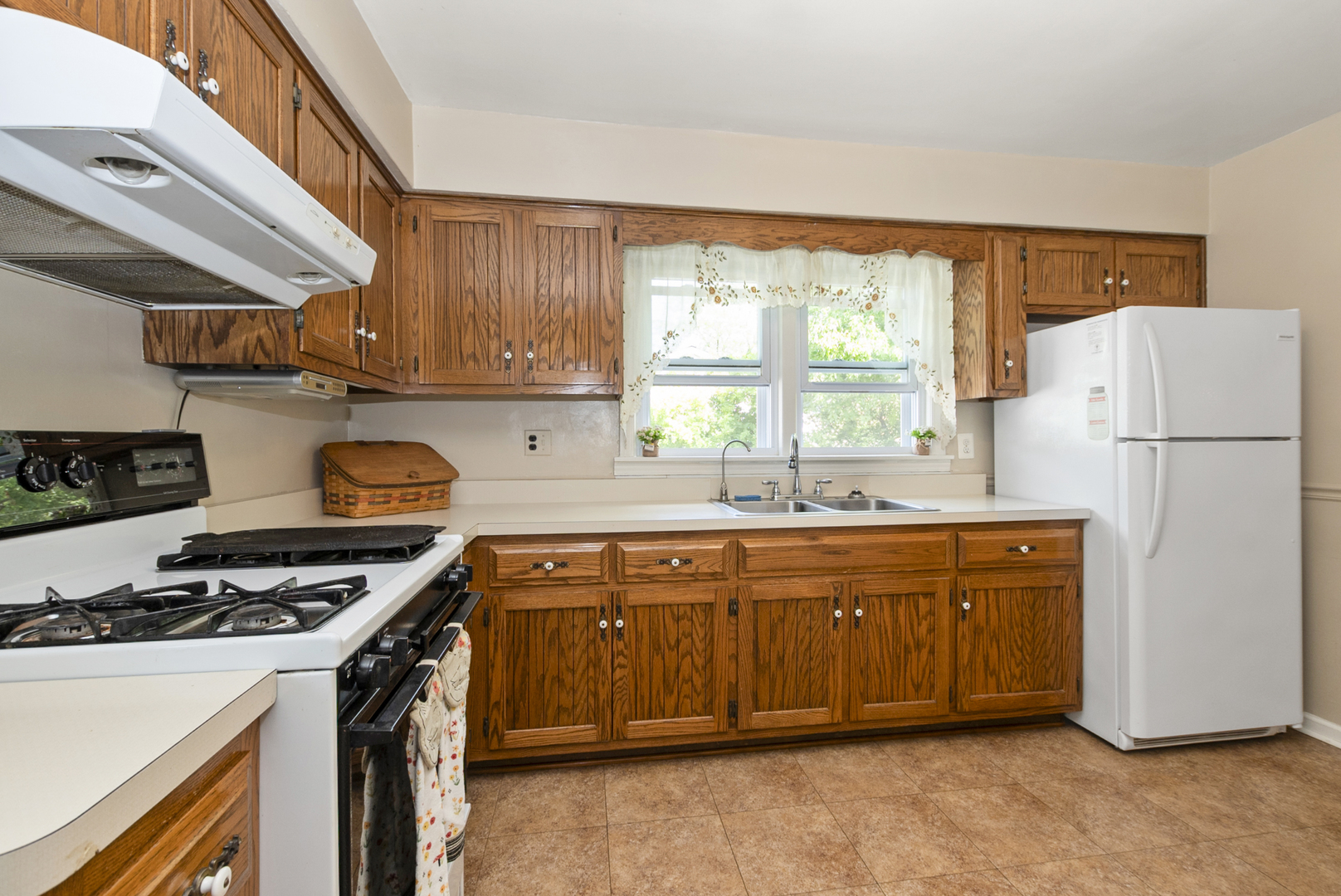 10832 Carpenter Street Mokena, IL 60448 - Photo 9 of 17 a kitchen with stainless steel appliances granite countertop a stove a sink and a refrigerator