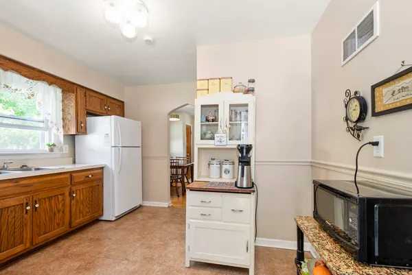 a kitchen with stainless steel appliances a refrigerator sink and cabinets