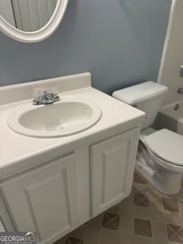 a bathroom with a sink and mirror