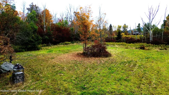 a backyard of a house with a yard and outdoor seating