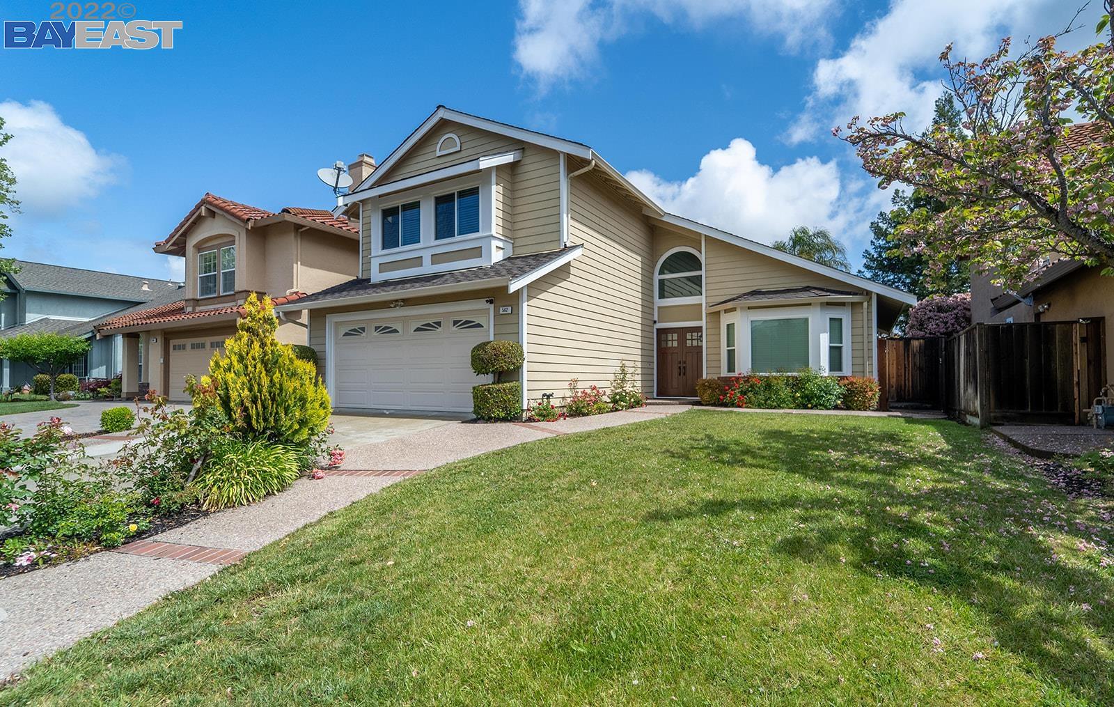 a front view of a house with a yard and garage
