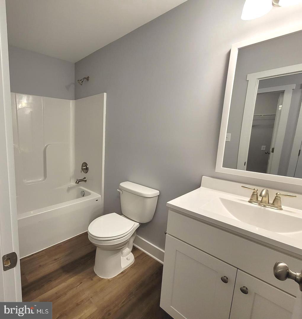 Plum Tree Lane Berkeley Springs, WV 25411 - Photo 14 of 18 a bathroom with a sink toilet a mirror and shower